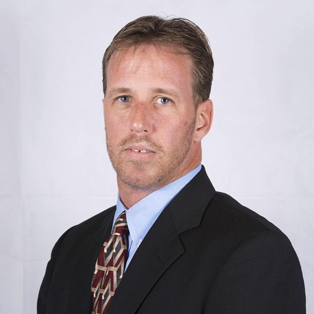 Josh Tullis Profile Headhshot in Suit and Tie